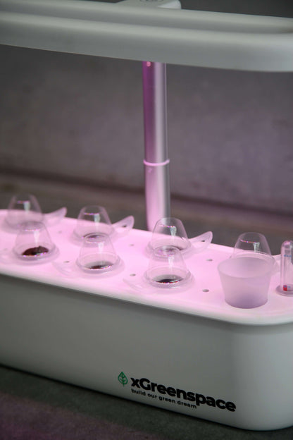 xGreenspace MiniBlock hydroponic system featuring 8 grow pods and LED lighting for indoor gardening.